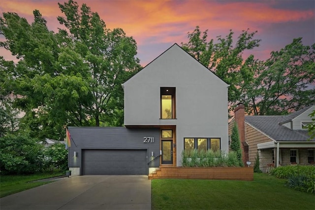 2711 W 49th St, Westwood, KS 66205 - view of front facade featuring driveway, a lawn, and an attached garage