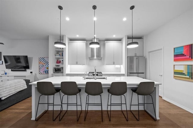2711 W 49th St, Westwood, KS 66205 - kitchen featuring stainless steel fridge, a large island, light countertops, a kitchen bar, and recessed lighting