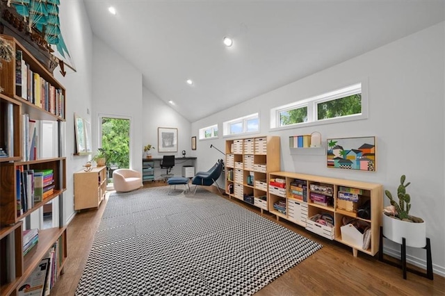2711 W 49th St, Westwood, KS 66205 - living area with high vaulted ceiling, wood finished floors, healthy amount of natural light, baseboards, and recessed lighting