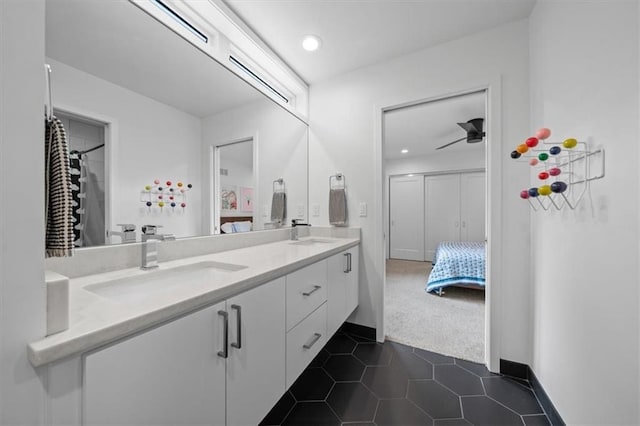 2711 W 49th St, Westwood, KS 66205 - bathroom featuring ensuite bathroom, double vanity, tile patterned floors, recessed lighting, and baseboards