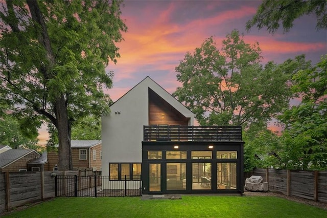 2711 W 49th St, Westwood, KS 66205 - back of house at dusk with a balcony