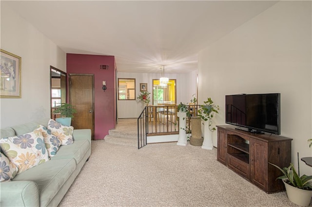 445 W 104th St Unit C, Kansas City, MO 64114 - living area featuring carpet floors, a chandelier, and healthy amount of natural light