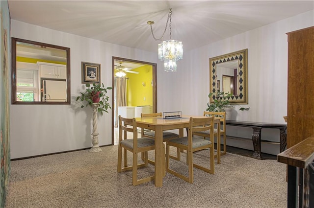 445 W 104th St Unit C, Kansas City, MO 64114 - dining area featuring carpet, a chandelier, a ceiling fan, and baseboards