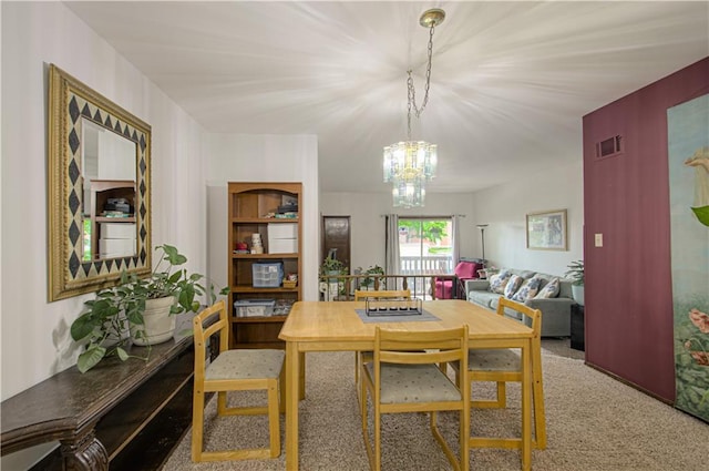 445 W 104th St Unit C, Kansas City, MO 64114 - dining space featuring a chandelier and carpet floors