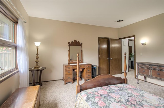 445 W 104th St Unit C, Kansas City, MO 64114 - bedroom with light colored carpet, multiple windows, and baseboards