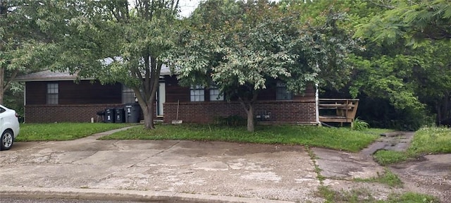 129 SE 235th St, Warrensburg, MO 64093 - view of property hidden behind natural elements featuring brick siding