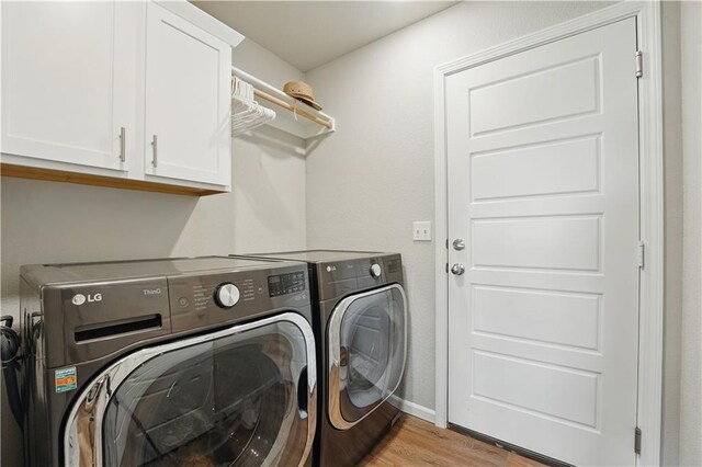 7546 Mccormick Dr, Shawnee, KS 66227 - washroom featuring washer and clothes dryer, cabinet space, and light wood-style floors
