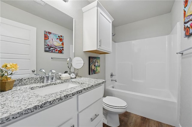 7546 Mccormick Dr, Shawnee, KS 66227 - bathroom with vanity, wood finished floors, and bathtub / shower combination