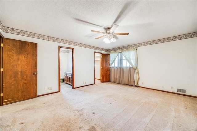 630 Oo Hwy, Centerview, MO 64019 - unfurnished bedroom with carpet floors, a textured ceiling, baseboards, connected bathroom, and ceiling fan