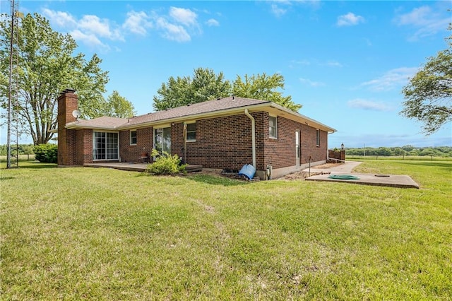 630 Oo Hwy, Centerview, MO 64019 - back of property featuring a patio, a chimney, brick siding, and a lawn