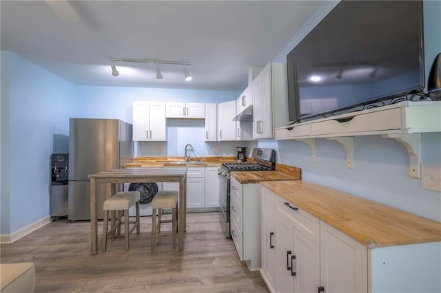 14001 S Tomahawk Dr, Olathe, KS 66062 - kitchen with appliances with stainless steel finishes, track lighting, and light wood-style flooring