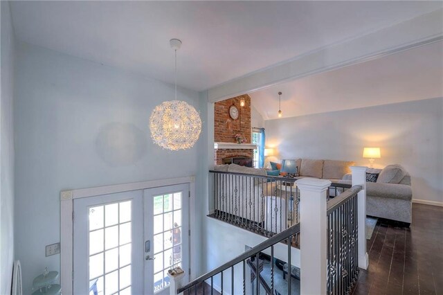 14001 S Tomahawk Dr, Olathe, KS 66062 - staircase with vaulted ceiling, wood finished floors, healthy amount of natural light, french doors, and a fireplace