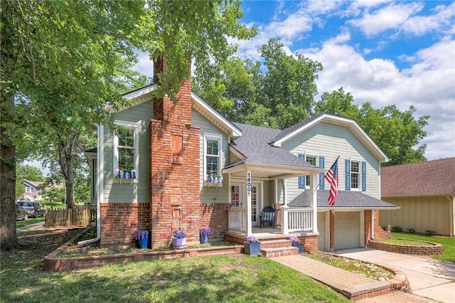 14001 S Tomahawk Dr, Olathe, KS 66062 - view of front facade featuring an attached garage, concrete driveway, a chimney, roof with shingles, and a porch