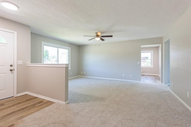 105 S W St, Concordia, MO 64020 - spare room featuring carpet floors, a ceiling fan, and a textured ceiling