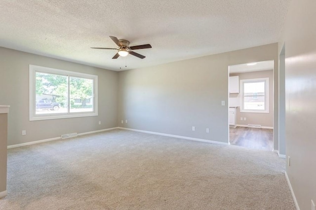 105 S W St, Concordia, MO 64020 - empty room featuring carpet, a ceiling fan, and a textured ceiling