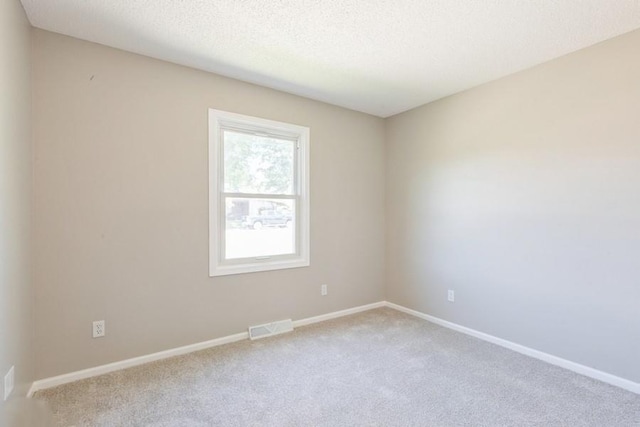 105 S W St, Concordia, MO 64020 - unfurnished room with carpet and a textured ceiling