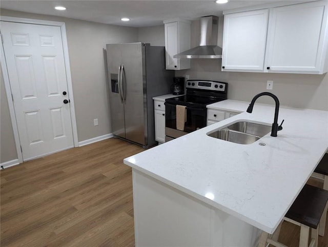 8804 E 47th St, Kansas City, MO 64129 - kitchen featuring wall chimney exhaust hood, appliances with stainless steel finishes, a sink, a peninsula, and recessed lighting