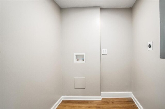 8804 E 47th St, Kansas City, MO 64129 - laundry room featuring hookup for an electric dryer, baseboards, washer hookup, and wood finished floors