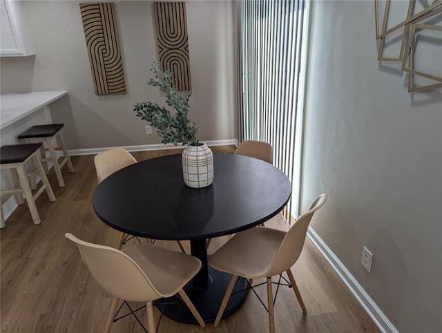 8804 E 47th St, Kansas City, MO 64129 - dining space with wood finished floors, baseboards, and stairs