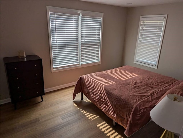 8804 E 47th St, Kansas City, MO 64129 - bedroom featuring wood finished floors, baseboards, and multiple windows