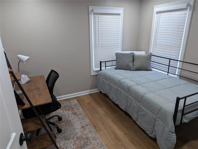 8804 E 47th St, Kansas City, MO 64129 - bedroom featuring wood finished floors, baseboards, and an office area