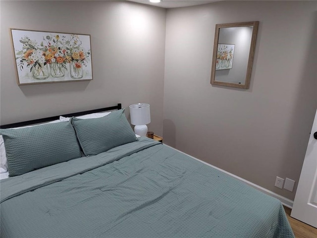8804 E 47th St, Kansas City, MO 64129 - bedroom featuring baseboards and wood finished floors