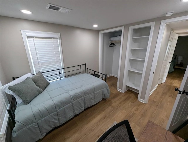 8804 E 47th St, Kansas City, MO 64129 - bedroom with baseboards, wood finished floors, and recessed lighting