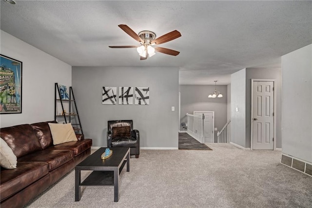 604 NE Ash St NE, Lees Summit, MO 64063 - living area featuring carpet flooring, a ceiling fan, a chandelier, and baseboards