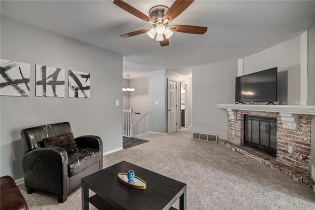 604 NE Ash St NE, Lees Summit, MO 64063 - living area with a ceiling fan, carpet flooring, a brick fireplace, and baseboards
