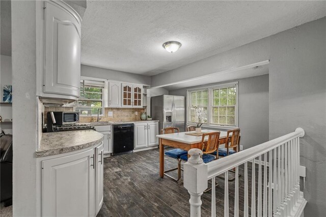 604 NE Ash St NE, Lees Summit, MO 64063 - kitchen with stainless steel appliances, dark wood-style flooring, white cabinets, light countertops, and plenty of natural light