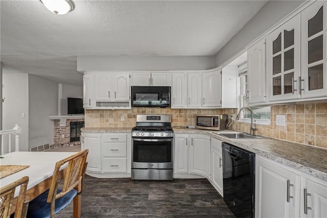 604 NE Ash St NE, Lees Summit, MO 64063 - kitchen with black appliances, a sink, white cabinets, glass insert cabinets, and dark wood-style flooring