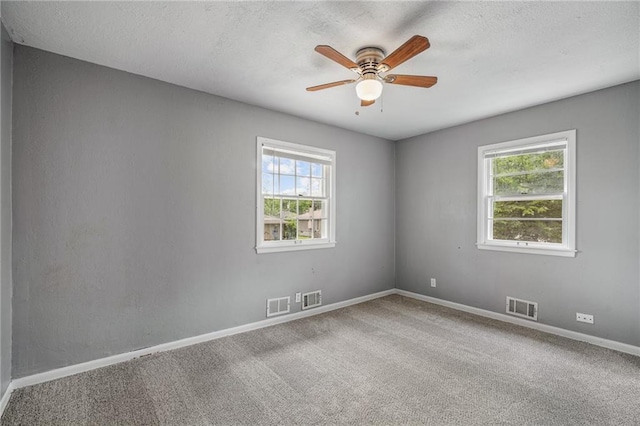 604 NE Ash St NE, Lees Summit, MO 64063 - carpeted empty room featuring ceiling fan, baseboards, and a textured ceiling