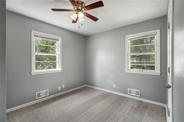 604 NE Ash St NE, Lees Summit, MO 64063 - spare room featuring carpet floors, baseboards, and a ceiling fan