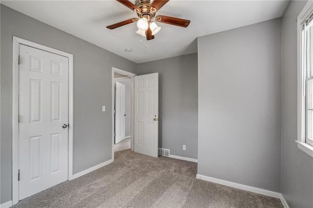 604 NE Ash St NE, Lees Summit, MO 64063 - unfurnished bedroom featuring carpet flooring, baseboards, and a ceiling fan