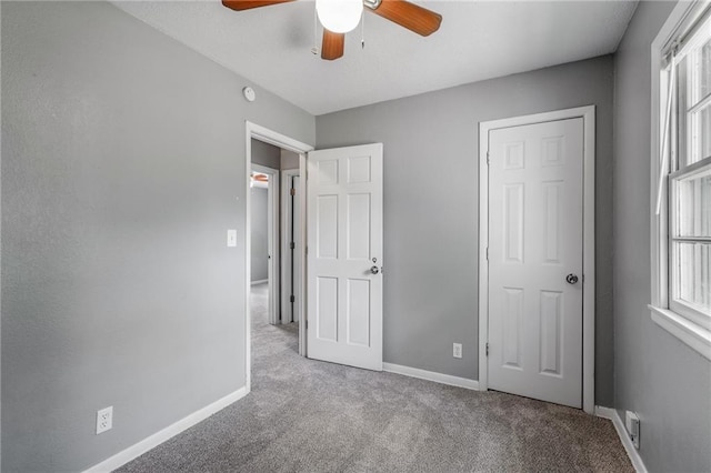 604 NE Ash St NE, Lees Summit, MO 64063 - unfurnished bedroom featuring carpet flooring, baseboards, and a ceiling fan