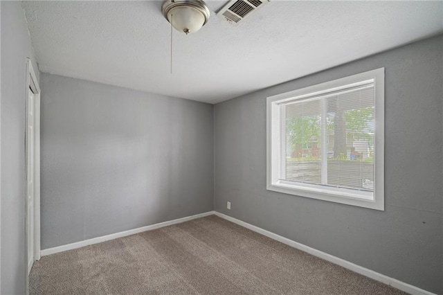 604 NE Ash St NE, Lees Summit, MO 64063 - carpeted spare room with baseboards and a textured ceiling