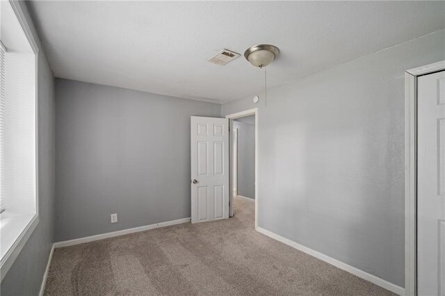 604 NE Ash St NE, Lees Summit, MO 64063 - carpeted spare room featuring baseboards