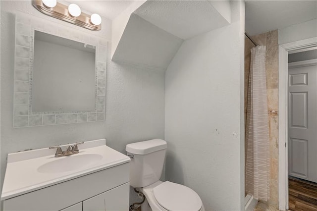 604 NE Ash St NE, Lees Summit, MO 64063 - bathroom featuring vanity, toilet, a stall shower, and wood finished floors