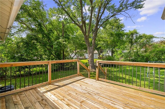 604 NE Ash St NE, Lees Summit, MO 64063 - wooden deck featuring a yard and view of scattered trees