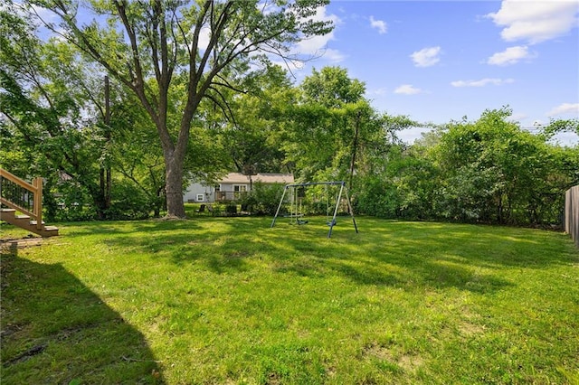 604 NE Ash St NE, Lees Summit, MO 64063 - view of grassy yard with a playground and stairs