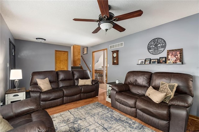 1229 SE Princeton Dr, Lees Summit, MO 64081 - living area with a ceiling fan, wood finished floors, and a textured ceiling