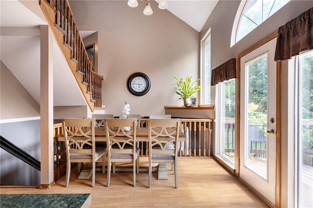1229 SE Princeton Dr, Lees Summit, MO 64081 - dining room featuring high vaulted ceiling, wood finished floors, and stairs