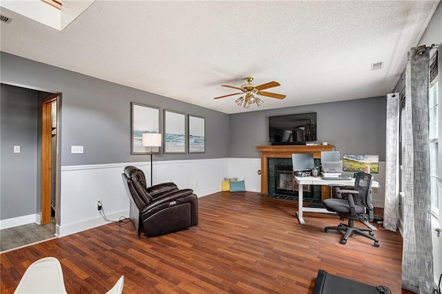 1229 SE Princeton Dr, Lees Summit, MO 64081 - office featuring a ceiling fan, wood finished floors, a fireplace, and a textured ceiling