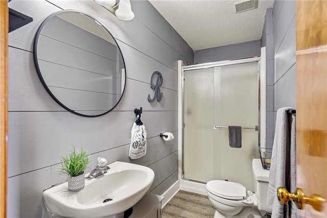 1229 SE Princeton Dr, Lees Summit, MO 64081 - full bathroom with a stall shower, wood finished floors, and a textured ceiling