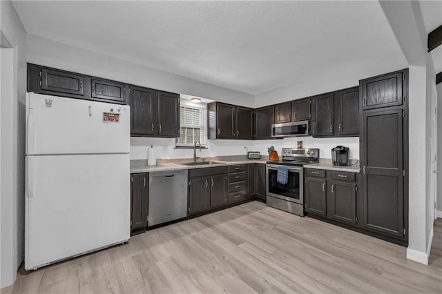 19133 E 15th St N, Independence, MO 64056 - kitchen with stainless steel appliances, a sink, light wood-style flooring, and light countertops