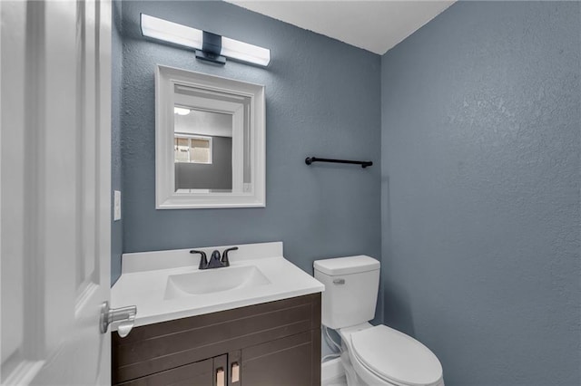 19133 E 15th St N, Independence, MO 64056 - bathroom with toilet, vanity, and a textured wall