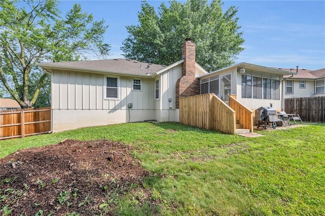 19133 E 15th St N, Independence, MO 64056 - back of property with board and batten siding, a chimney, a sunroom, and roof with shingles