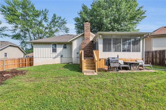 19133 E 15th St N, Independence, MO 64056 - back of property featuring a sunroom, a chimney, and board and batten siding