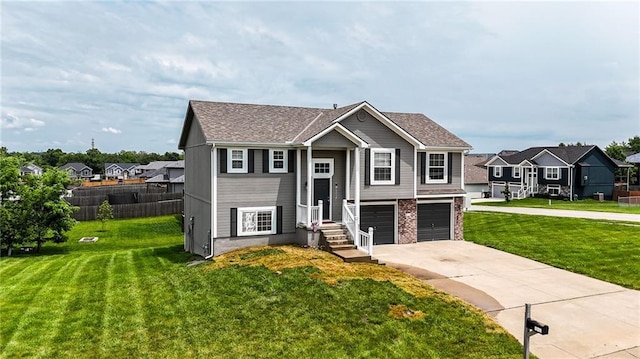 614 SW Tisha Ln, Grain Valley, MO 64029 - split foyer home with concrete driveway, a residential view, and a garage