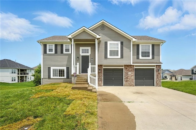 614 SW Tisha Ln, Grain Valley, MO 64029 - bi-level home featuring driveway, a front lawn, and an attached garage
